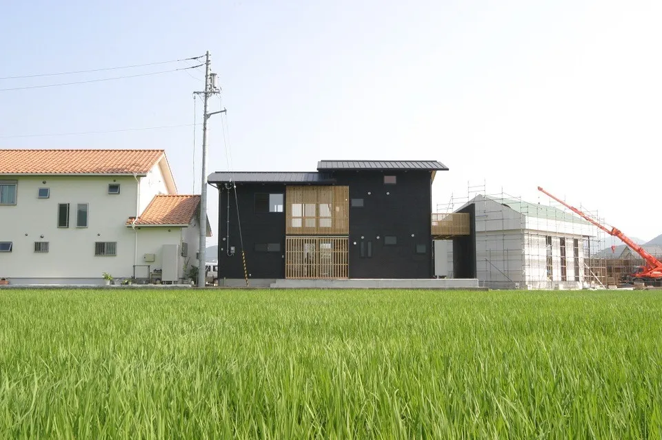 田んぼの中の小規模な住宅宅地に建ち、外部への抜けの良さを求めながらプラベイトを意識した4人家族の家
